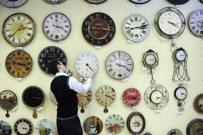 Консультант магазина часов в Санкт-Петербурге переводит стрелки на летнее время. Фото: Сергей Ермохин РИА Новости